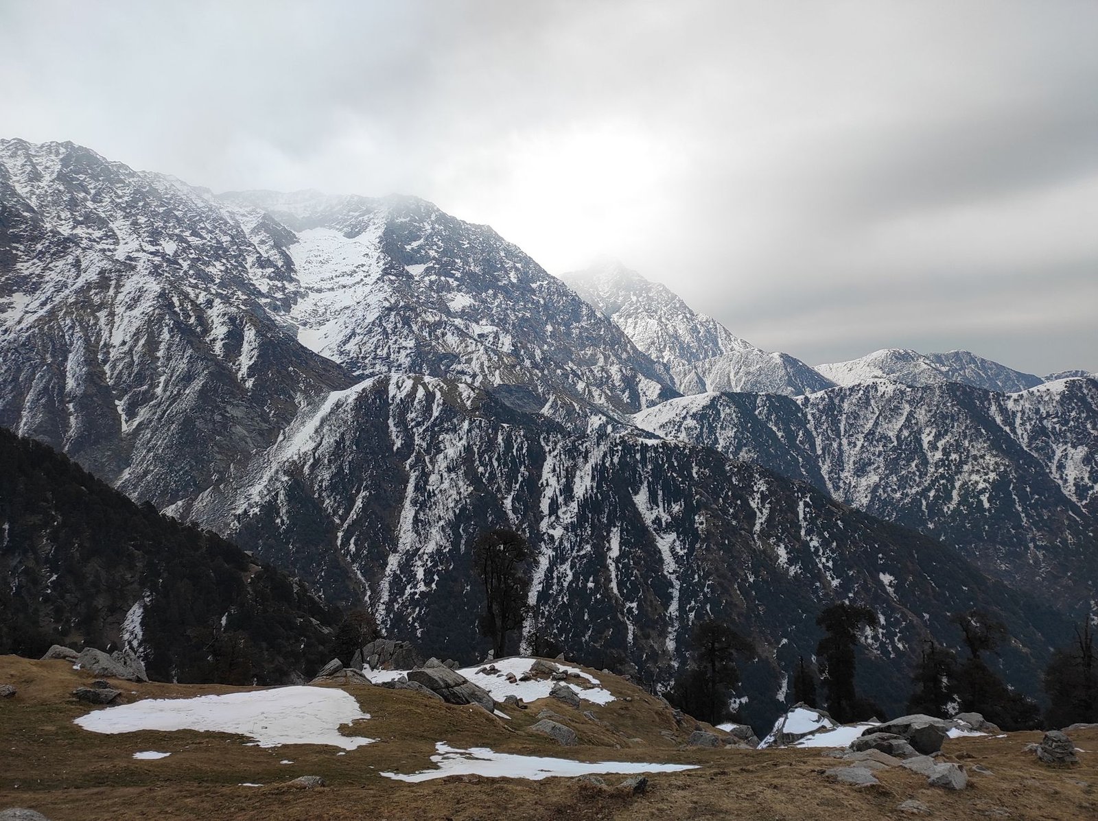 Breathtaking view of snow-covered Himalayan peaks in Dharamshala, India.