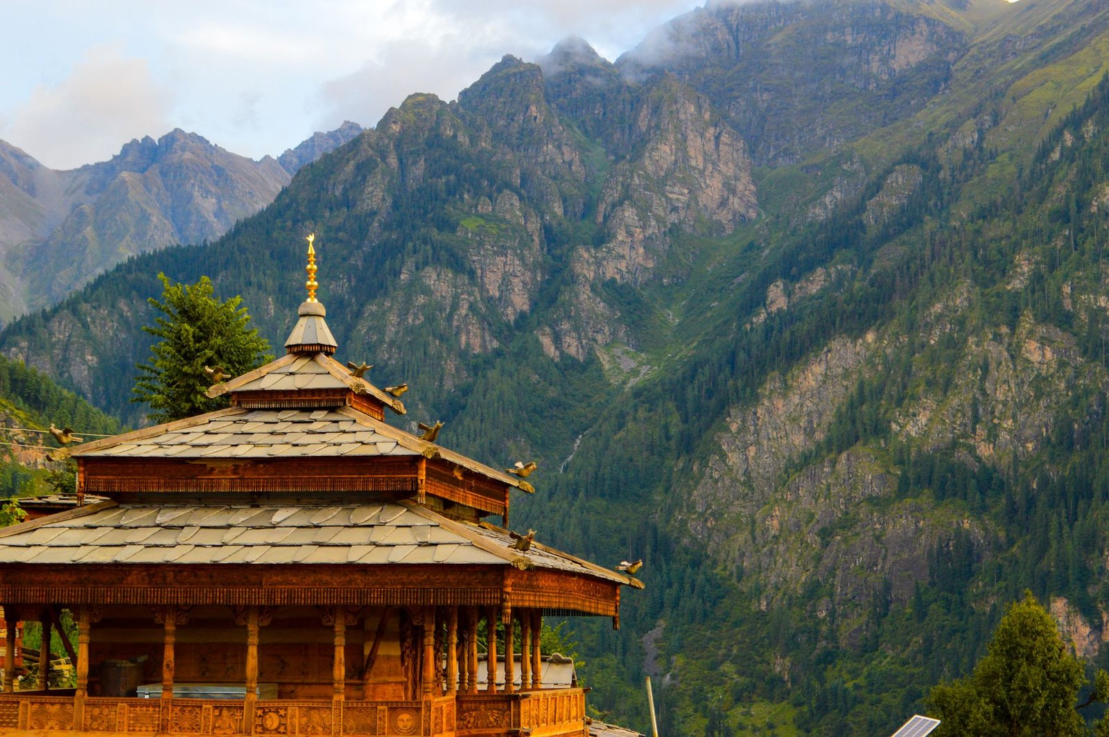 Discover a serene Himachal Pradesh temple set against stunning mountain backdrops, capturing Indian architecture.