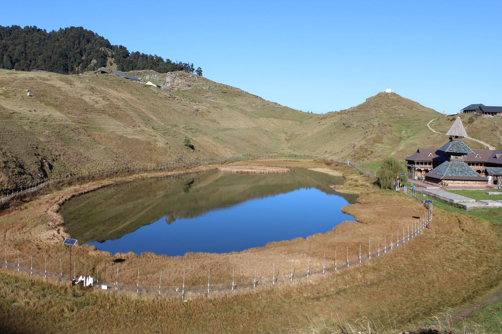 A breathtaking aerial shot capturing Prashar Lake and the temple in serene surroundings at D.P.F. Parashar Dhar, Himachal Pradesh, India.