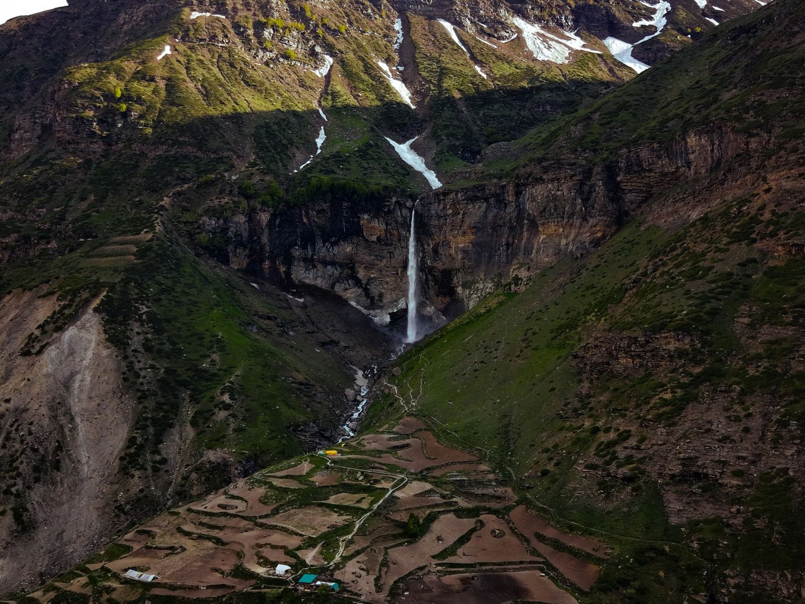 A breathtaking view of a waterfall cascading down a mountain in Sissu, Himachal Pradesh, India.