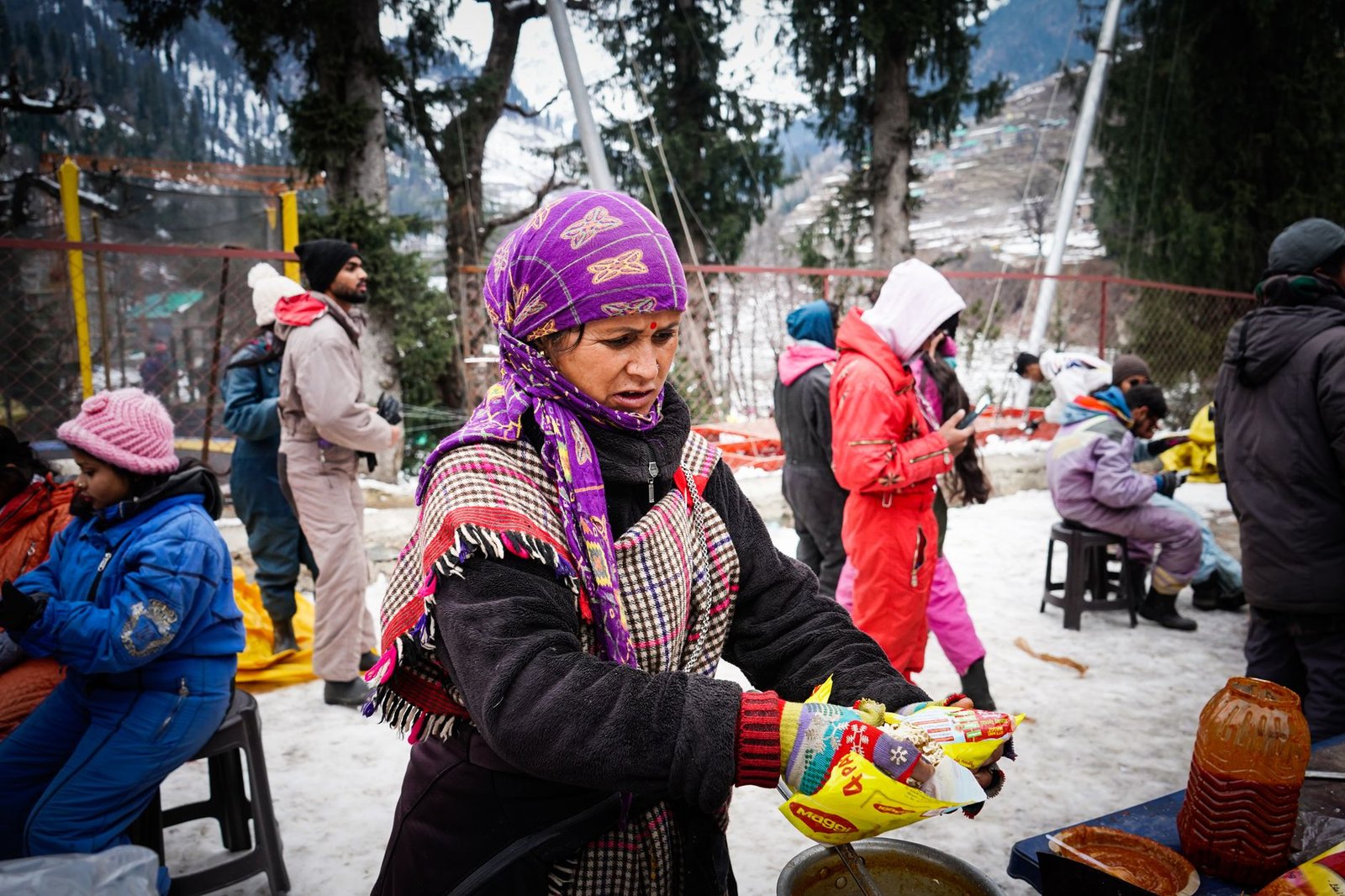 Street vendor serves customers at a vibrant winter bazaar in Himachal Pradesh.