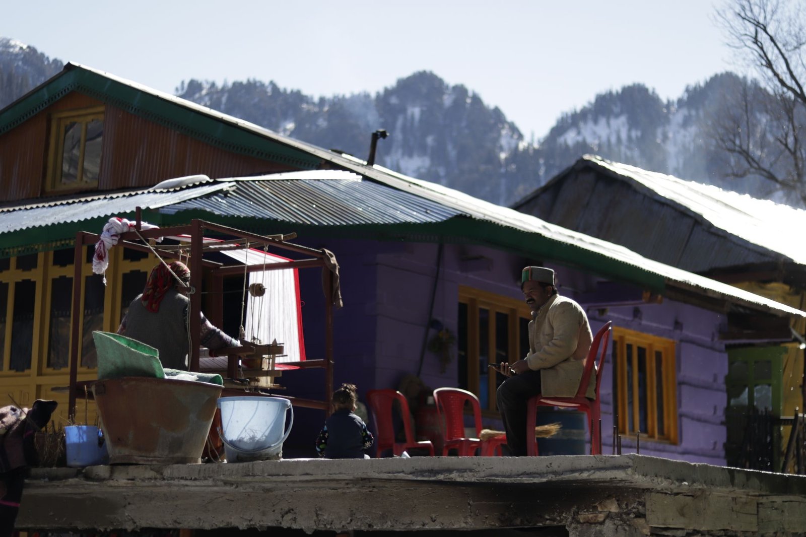 Traditional rural life captured against a picturesque mountain background, reflecting cultural simplicity.
